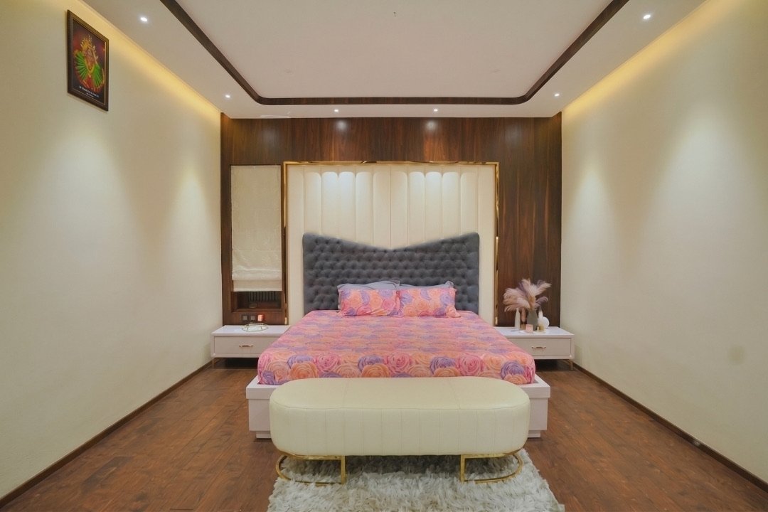 Bedroom with tufted headboard and walnut panelling by HOH Luxe