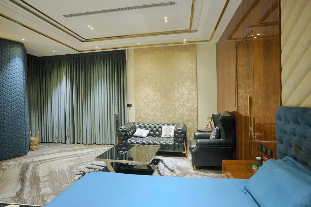 Master suite seating area with velvet drapes by HOH Luxe