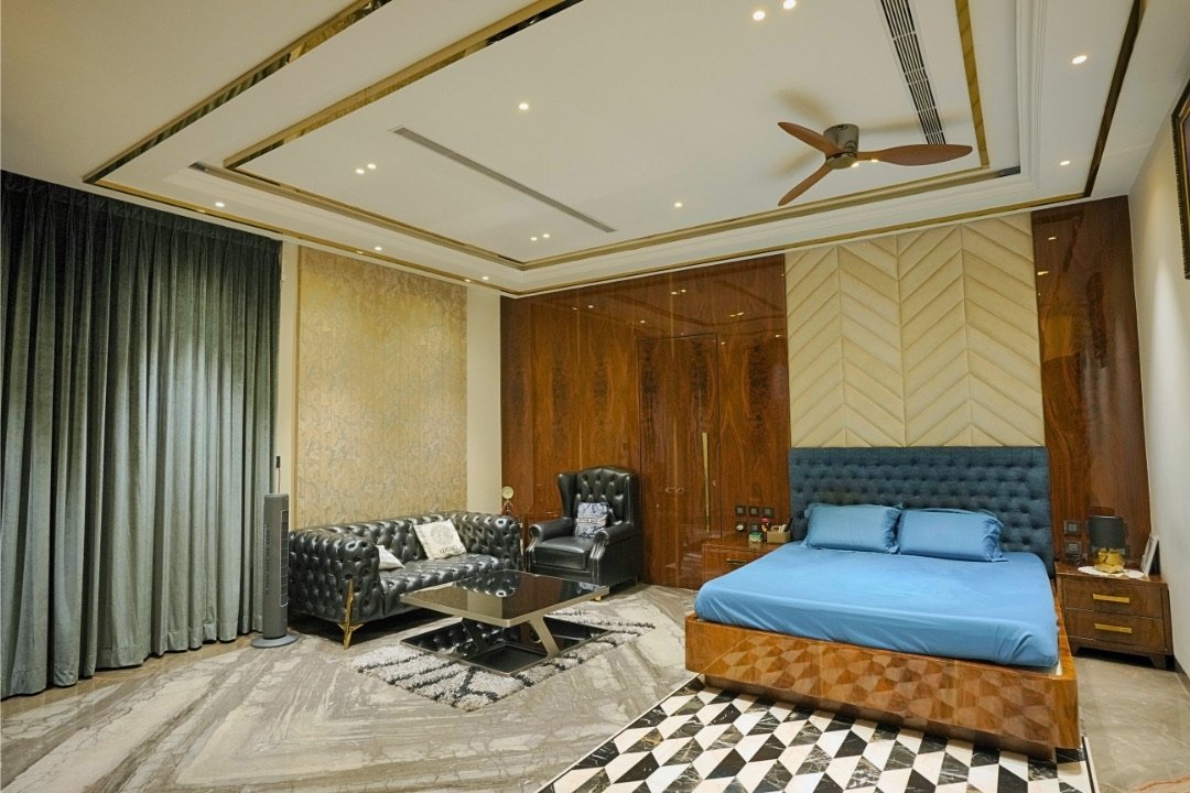 Master bedroom with walnut wardrobes and chevron wall panelling by HOH Luxe